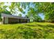 Expansive backyard, ideal for entertaining, featuring a patio area, lush grass, and mature trees at 1104 Margaret Dr, Ladson, SC 29456