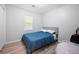 Well-lit bedroom featuring wood-look floors and a comfortable bed at 1104 Margaret Dr, Ladson, SC 29456