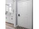 This home's entryway leads to a kitchen featuring white cabinets, modern fixtures, and ample natural light at 1104 Margaret Dr, Ladson, SC 29456