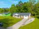 Aerial view of a charming brick home with a well-kept lawn and a long driveway on a sunny day at 1104 Margaret Dr, Ladson, SC 29456