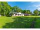 Wide angle shot of the exterior of the property featuring green lawn and brick facade in a neighborhood setting at 1104 Margaret Dr, Ladson, SC 29456