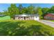 Charming single-story brick home featuring a well-maintained lawn, classic design, and mature trees at 1104 Margaret Dr, Ladson, SC 29456