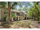 Exterior of villas surrounded by a natural landscape with mature trees and leaf-covered ground at 113 High Hammock Villas, Seabrook Island, SC 29455