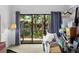 Bedroom with glass doors leading to outdoor deck and natural light at 113 High Hammock Villas, Seabrook Island, SC 29455