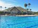Stunning community pool with palm trees, splash pad and a view of the clubhouse at 113 High Hammock Villas, Seabrook Island, SC 29455