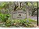 High Hammock Villas community sign featuring lush greenery and mature trees at 113 High Hammock Villas, Seabrook Island, SC 29455