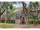 Charming condo with covered stairwell entrance surrounded by palm trees and lush landscaping at 113 High Hammock Villas, Seabrook Island, SC 29455