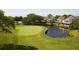 Beautiful golf course featuring a pond with a green and townhouses in the background at 113 High Hammock Villas, Seabrook Island, SC 29455