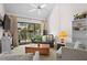 Comfortable living room showcasing vaulted ceilings, plush seating, and access to a balcony at 113 High Hammock Villas, Seabrook Island, SC 29455