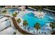 A beautiful resort pool area with ample lounge chairs, umbrellas, and lush palm trees for ultimate relaxation and vacation enjoyment at 113 High Hammock Villas, Seabrook Island, SC 29455