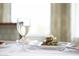 Elegant table setting with a glass of crisp white wine and a delicious meal at 113 High Hammock Villas, Seabrook Island, SC 29455
