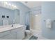 Bright bathroom with white vanity, toilet, and tub/shower featuring a stylish shower curtain at 114 W Arctic Ave # B302, Folly Beach, SC 29439