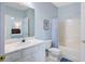 Bright bathroom with white vanity, toilet, and tub/shower featuring a stylish shower curtain at 114 W Arctic Ave # B302, Folly Beach, SC 29439