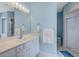 Light and airy bathroom with white cabinets, marble countertops, and a glass-enclosed shower at 114 W Arctic Ave # B302, Folly Beach, SC 29439