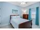 Bright bedroom with light blue walls, a cozy queen-sized bed, and a dresser at 114 W Arctic Ave # B302, Folly Beach, SC 29439