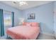 Relaxing bedroom with a plush pink bed, a view of the ocean, and a ceiling fan at 114 W Arctic Ave # B302, Folly Beach, SC 29439