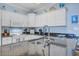 Kitchen with plenty of counter space with white cabinets and stainless steel sink at 114 W Arctic Ave # B302, Folly Beach, SC 29439