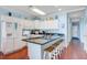 Bright kitchen with modern white appliances, center island and wooden floors at 114 W Arctic Ave # B302, Folly Beach, SC 29439