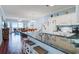 Bright kitchen and living area boasts a center island, wooden floors, and comfortable furnishings at 114 W Arctic Ave # B302, Folly Beach, SC 29439