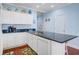 Well-lit kitchen featuring white cabinetry, granite countertops, and stainless-steel appliances at 114 W Arctic Ave # B302, Folly Beach, SC 29439