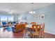 Bright living area with a leather sofa, dining table, and balcony access showcasing a scenic outdoor view at 114 W Arctic Ave # B302, Folly Beach, SC 29439