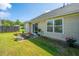 Cozy outdoor patio features seating and lush potted plants, enhancing the charm of the manicured green backyard at 1209 River Rock Rd, Hanahan, SC 29410