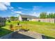 Spacious backyard with patio, table, chairs, green lawn, and perimeter fence at 1209 River Rock Rd, Hanahan, SC 29410