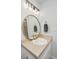 Bathroom vanity with gold faucet, round mirror, and modern lighting at 1209 River Rock Rd, Hanahan, SC 29410