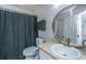 Bathroom featuring a toilet, vanity with round mirror, and a shower with gray curtain at 1209 River Rock Rd, Hanahan, SC 29410