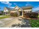Inviting single-story home with a well-maintained lawn and driveway at 1209 River Rock Rd, Hanahan, SC 29410