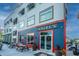 Three story commercial building with a blue and red sign with benches in front of the entrance at 1209 River Rock Rd, Hanahan, SC 29410
