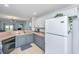 Efficient kitchen with white cabinets and modern appliances, open to the living area at 1209 River Rock Rd, Hanahan, SC 29410