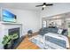 Bright living room features a cozy fireplace and open access to the dining area at 1209 River Rock Rd, Hanahan, SC 29410