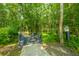 Wooded walking path featuring a charming bridge and a birdhouse; a tranquil outdoor retreat at 1209 River Rock Rd, Hanahan, SC 29410