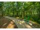 Outdoor fitness trail through wooded green community area with curved cement walking trail at 1209 River Rock Rd, Hanahan, SC 29410