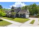 Well-maintained home featuring an attached garage and a neatly manicured lawn with sidewalk at 1233 Updyke Dr, Johns Island, SC 29455