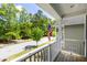 Inviting front porch overlooking a quiet street, features an American flag adding to the neighborhood charm at 1233 Updyke Dr, Johns Island, SC 29455