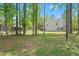 A large private backyard nestled in a lush, wooded setting offers serene outdoor space at 1325 Wannamaker Ave, Summerville, SC 29485