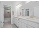 Bright bathroom with double vanity, quartz countertop, tiled floors, and a view into a tiled shower at 1325 Wannamaker Ave, Summerville, SC 29485