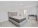 Carpeted bedroom with a modern platform bed, a desk, and open doorways to a hallway and bathroom at 1325 Wannamaker Ave, Summerville, SC 29485