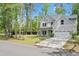 Beautiful two-story home with a well-manicured lawn and a mix of mature trees and new plantings at 1325 Wannamaker Ave, Summerville, SC 29485