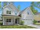 Charming two-story home featuring gray siding, a covered porch, and an attached two-car garage at 1325 Wannamaker Ave, Summerville, SC 29485