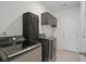 Functional laundry room equipped with modern washer and dryer units and overhead storage cabinets at 1325 Wannamaker Ave, Summerville, SC 29485