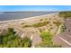 Breathtaking aerial view of beachfront community with sandy beach, lush vegetation, and winding boardwalks at 1342 Pelican Watch Villas, Seabrook Island, SC 29455