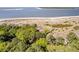 Stunning aerial view of beachside villas surrounded by lush trees, offering a serene and private escape at 1342 Pelican Watch Villas, Seabrook Island, SC 29455