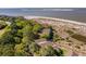 Scenic aerial shot showcases villas next to the beach, bordered by mature trees for added privacy at 1342 Pelican Watch Villas, Seabrook Island, SC 29455