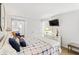 Bright bedroom features a comfortable bed, a TV, and a charming sitting area at 1342 Pelican Watch Villas, Seabrook Island, SC 29455