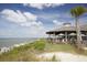 Scenic patio view of building with tables, beach access, and ocean backdrop at 1342 Pelican Watch Villas, Seabrook Island, SC 29455