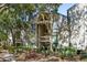 Exterior view of a condo complex with stairs to units, surrounded by trees, shrubs and mulch beds at 1342 Pelican Watch Villas, Seabrook Island, SC 29455