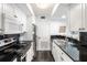 Efficient kitchen design with sleek black countertops, stainless steel appliances, and white cabinetry at 1342 Pelican Watch Villas, Seabrook Island, SC 29455